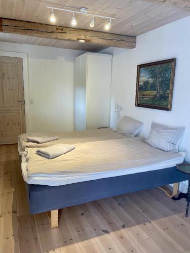 a bedroom with a large bed in a room at Strågården Nyord in Nyord