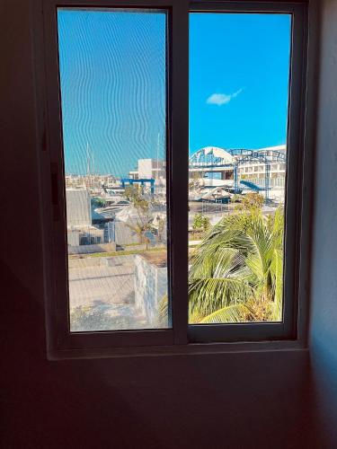 a window in a room with a view of a city at Apartments & Rooms in Cancun next to the beach in Cancún