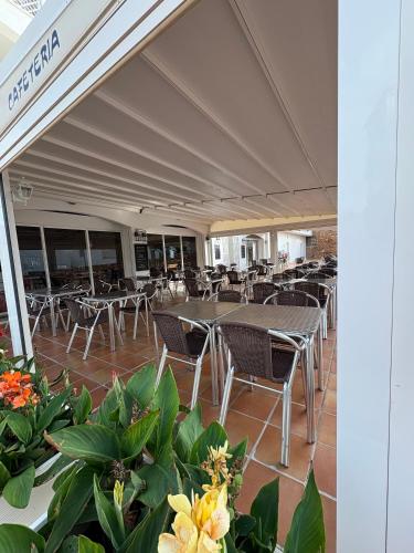 a row of tables and chairs in a building at APCOSTAS - Complejo Al Andalus in Alcossebre