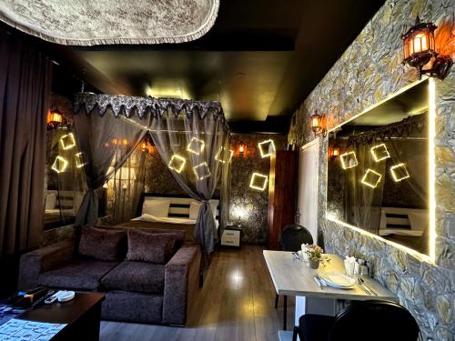 a room with a bed and a couch and a table at City Hotel Baku in Baku