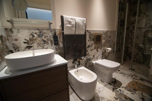 a bathroom with a sink and a toilet at Duse Luxury Stay in Milan