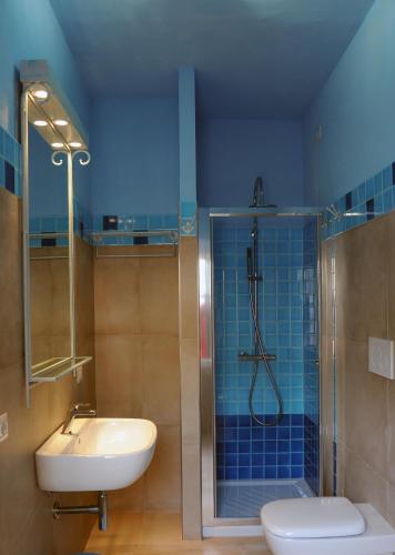 a bathroom with a shower and a sink and a toilet at Alghero Sunrise in Alghero