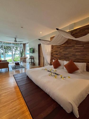 a bedroom with a large bed with flowers on it at Ambong Pool Villas - Private Pool in Pantai Cenang