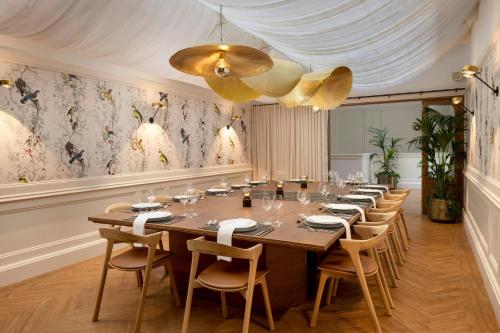 a large dining room with a long table and chairs at AC Hotel by Marriott Glasgow in Glasgow