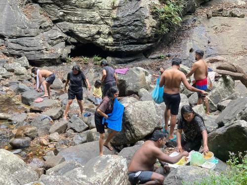 a group of people standing on rocks in the water at Meemure traval master in Meemure