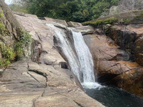 a waterfall on the side of a rocky mountain at Meemure traval master in Meemure