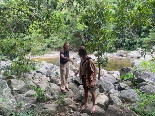 two women standing on rocks near a river at Meemure traval master in Meemure