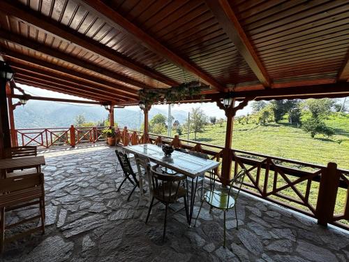 a patio with a table and chairs on a balcony at Tiny Maxi House in Hopa