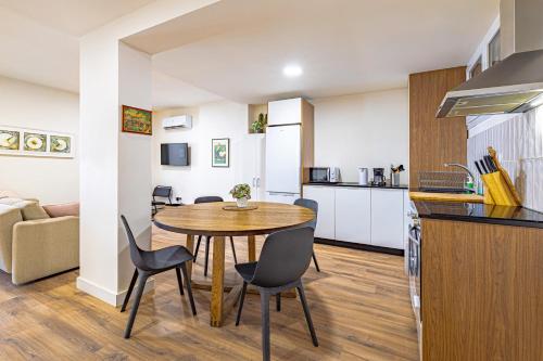 a kitchen and dining room with a table and chairs at GMC Turistics - Paseo Marítimo Estepona in Estepona