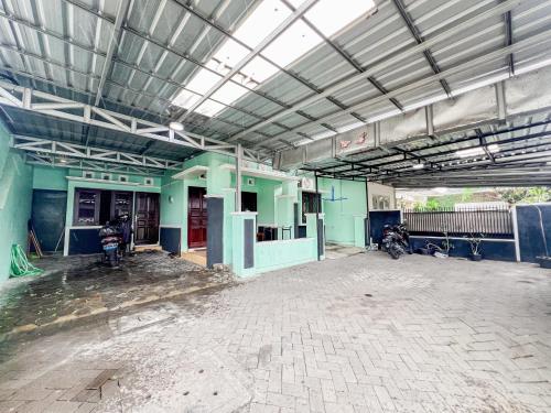 an empty building with a motorcycle parked in it at Omah Seturan Homestay Jogja in Seturan