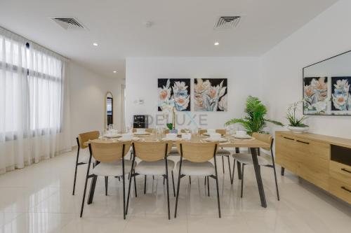 a dining room with a table and chairs at Coastal Escape with Private Pool, Breathtaking Sea And Mountain Views, Near Al Aqah Beach - Al Dana Island, Fujairah by Deluxe Holiday Homes in Fujairah
