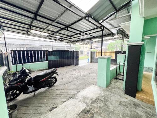 a motorcycle parked inside of a building at Omah Seturan Homestay Jogja in Seturan