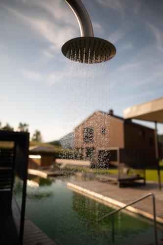 a water sprinkler hanging over a pool of water at ADEA Lifestyle Suites Fieberbrunn in Fieberbrunn