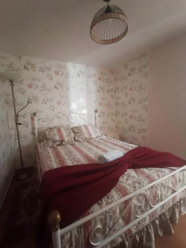 a bedroom with a bed with floral wallpaper at Barnhouse Duplex in Idanha-a-Nova