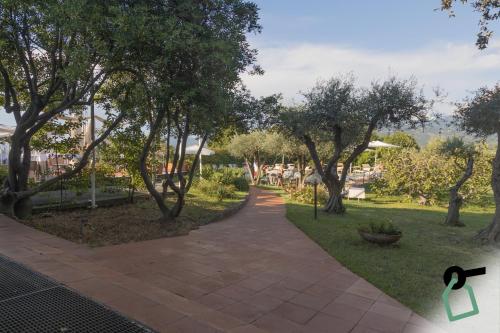 a walkway in a park with trees and grass at HOTIDAY Room Collection - Sarzana in Sarzana