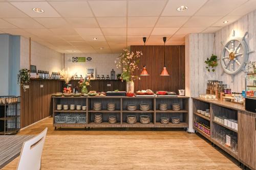 a room with a counter and shelves with food at Court Garden Hotel in The Hague