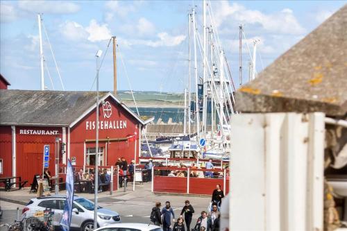 a group of people walking around a marina with boats at 717-Thyboron-Jernbanegade-3 in Thyborøn