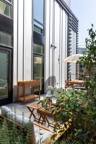 a patio with tables and chairs on a building at Inkwell Charlotte in Charlotte