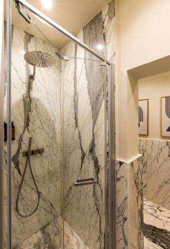 a shower with a glass door in a bathroom at Nerva Boutique Hotel in Rome