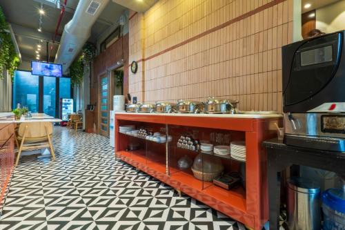 a restaurant with a counter with pots and pans at Cosy Grand, Chanakyapuri by The Cosy Hotels in New Delhi
