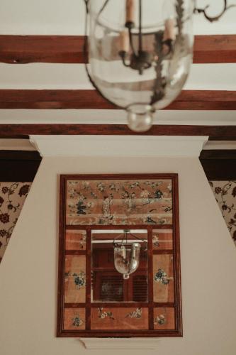 a chandelier and a window in a room at Rondaia, a Winery & Fincahotel-Agroturismo in Tramuntana in Esporles