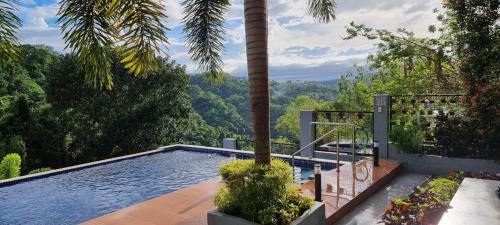 a swimming pool with a view of the mountains at Abed Villa Tagaytay in Tagaytay