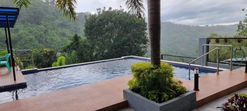 a swimming pool with a view of a mountain at Abed Villa Tagaytay in Tagaytay