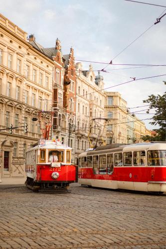 two trolley cars parked in front of a building at INNSiDE by Meliá Prague Old Town in Prague