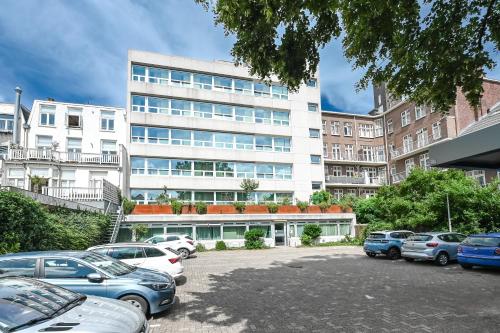 a parking lot in front of a large building at Court Garden Hotel in The Hague