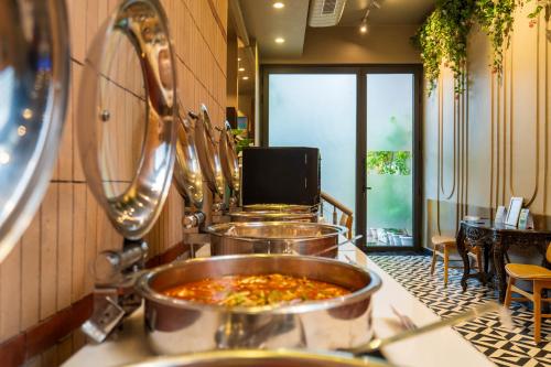 a large pot of food on a counter in a restaurant at Cosy Grand, Chanakyapuri by The Cosy Hotels in New Delhi