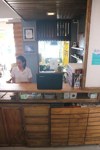 a woman sitting at a counter in a office at Zuzuni Boutique Hotel in Boracay