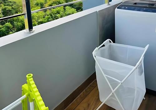 a laundry room with a washing machine and a window at Evara Luxury Living Central 3BHK near HITEC City in Hyderabad