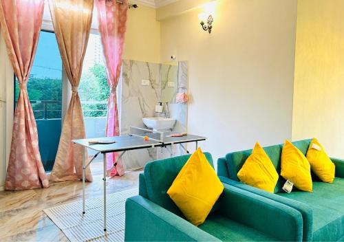 a living room with a blue couch and yellow pillows at Evara Luxury Living Central 3BHK near HITEC City in Hyderabad