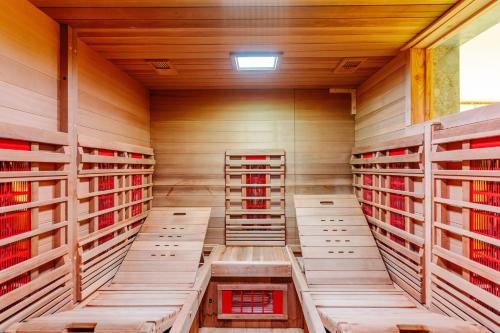 a wine cellar with wooden racks of wine bottles at La Ferme d'Auwez - Arbre de vie - Gîte 4 pers avec piscines et sauna in Ciney