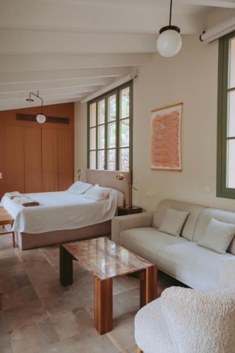 a living room with two beds and a couch at Rondaia, a Winery & Fincahotel-Agroturismo in Tramuntana in Esporles