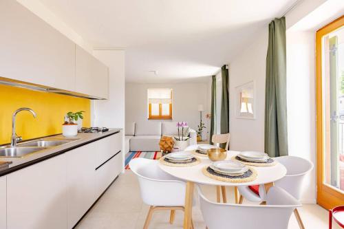 a kitchen and dining room with a table and chairs at Casa Pradiei Dolomiti View in Cavareno