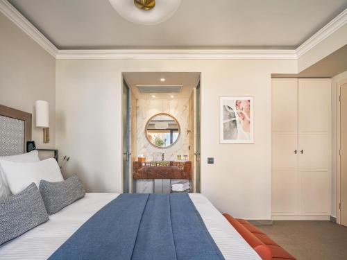 a bedroom with a large bed and a bathroom at Aegean Melathron Thalasso Spa Hotel in Kallithea Halkidikis