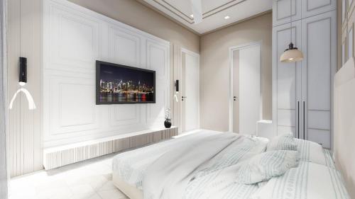 a white bedroom with a bed and a tv on the wall at Sunset view Villa I Luxury 5 BHK Villa in Nathdwara I 966o336o69 I Stay in Nathdwara in Nāthdwāra