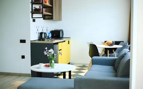 a living room with a couch and a table at Rooms Apart Hotel by RED in Yerevan