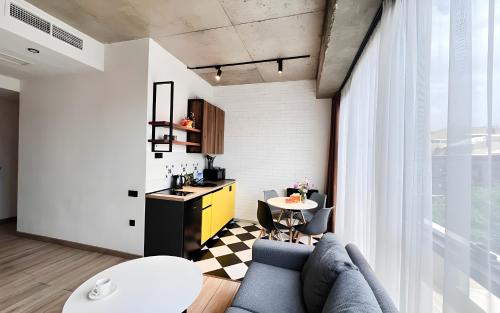 a living room with a couch and a table at Rooms Apart Hotel by RED in Yerevan