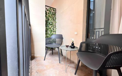 a room with two chairs and a table at Rooms Apart Hotel by RED in Yerevan
