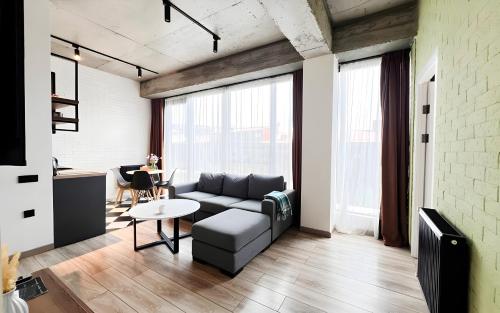 a living room with a couch and a table at Rooms Apart Hotel by RED in Yerevan
