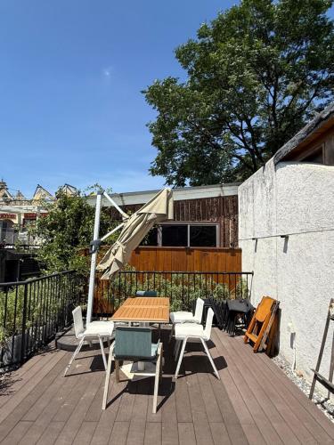 a patio with a table and chairs on a deck at Once Linya Xiaoyuan in Chongqing