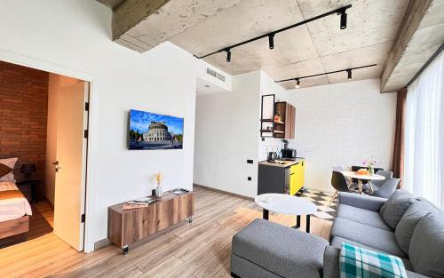 a living room with a couch and a table at Rooms Apart Hotel by RED in Yerevan