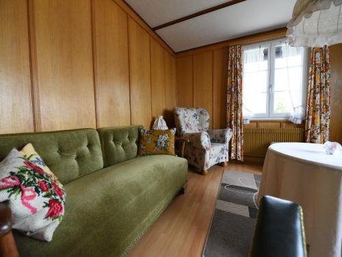 a living room with a green couch and a table at Apartment in Trans Village in Trans