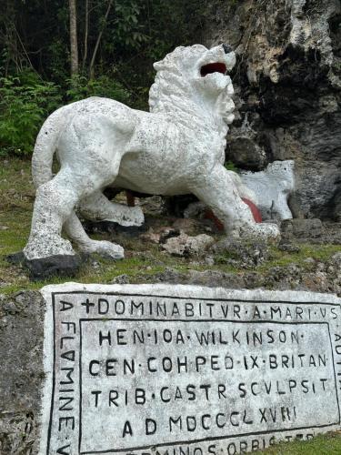 a statue of a lion standing next to a sign at T.Cole’s Holiday Rental in Saint James