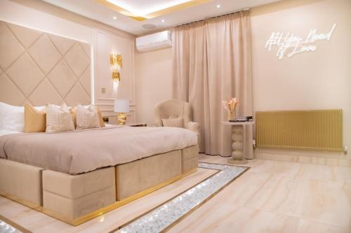 a bedroom with a king sized bed and a chair at Optimal Apartments Huddersfield in Huddersfield