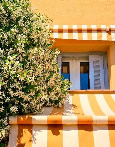 a building with flowers on the side of it at Hôtel La Pérouse Nice Baie des Anges in Nice