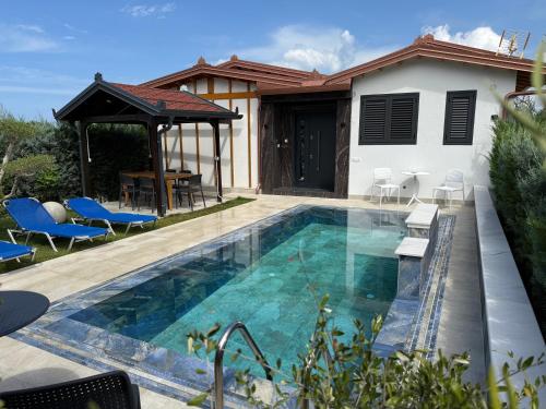 a swimming pool in front of a house at Villa REJA Hamallaj in Draçi