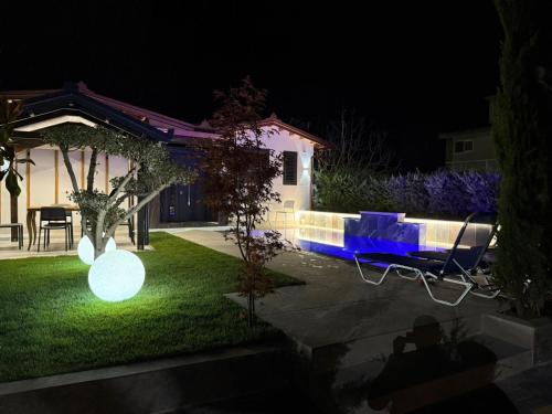 a backyard at night with lights on the grass at Villa REJA Hamallaj in Draçi